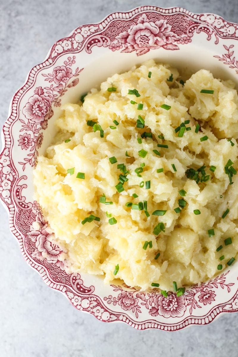 A bowl of mashed parsnips topped with snipped chives