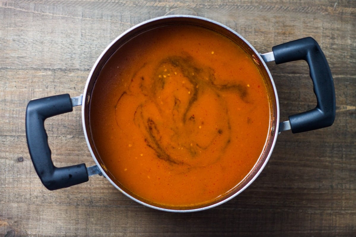 An overhead shot of a saucepan filled with low FODMAP tomato soup 