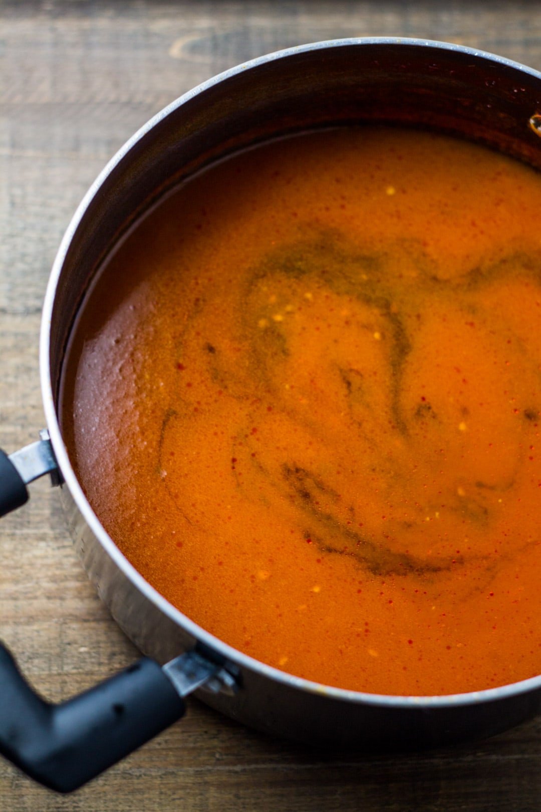 A close up shot of a saucepan filled with low FODMAP tomato soup