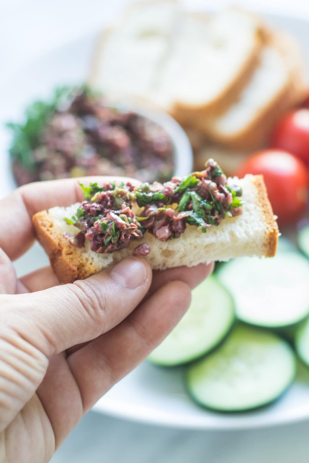 Piece of gluten-free bread topped with homemade olive tapenade