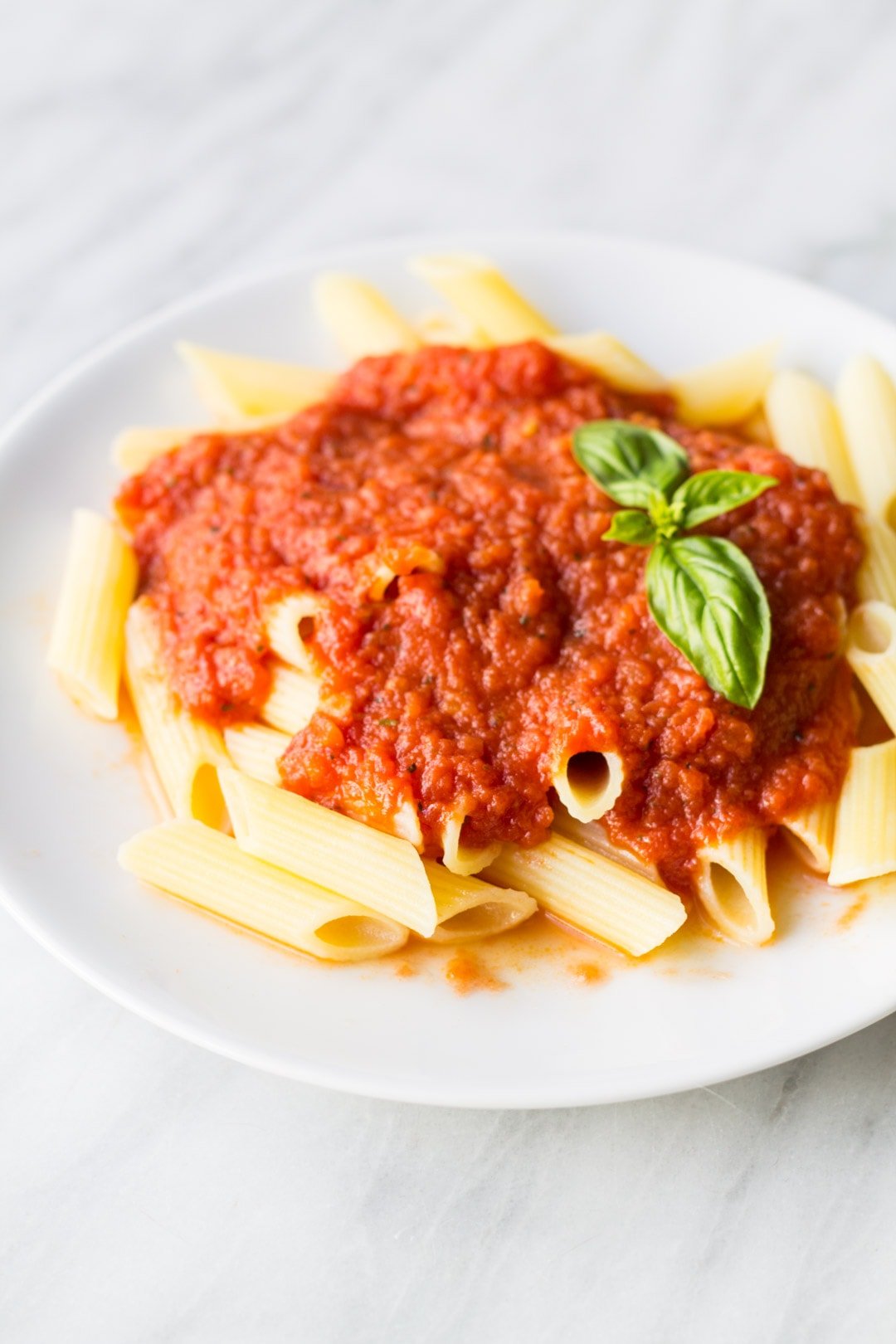 Plate with low FODMAP pasta sauce over gluten free penne