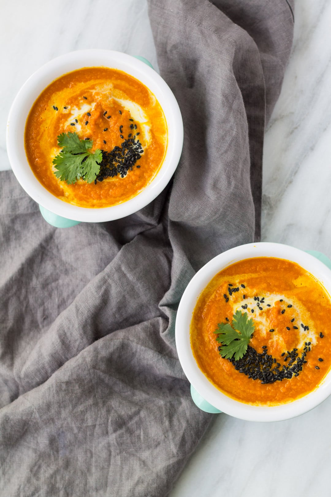 Two bowls of low FODMAP carrot and tomato soup