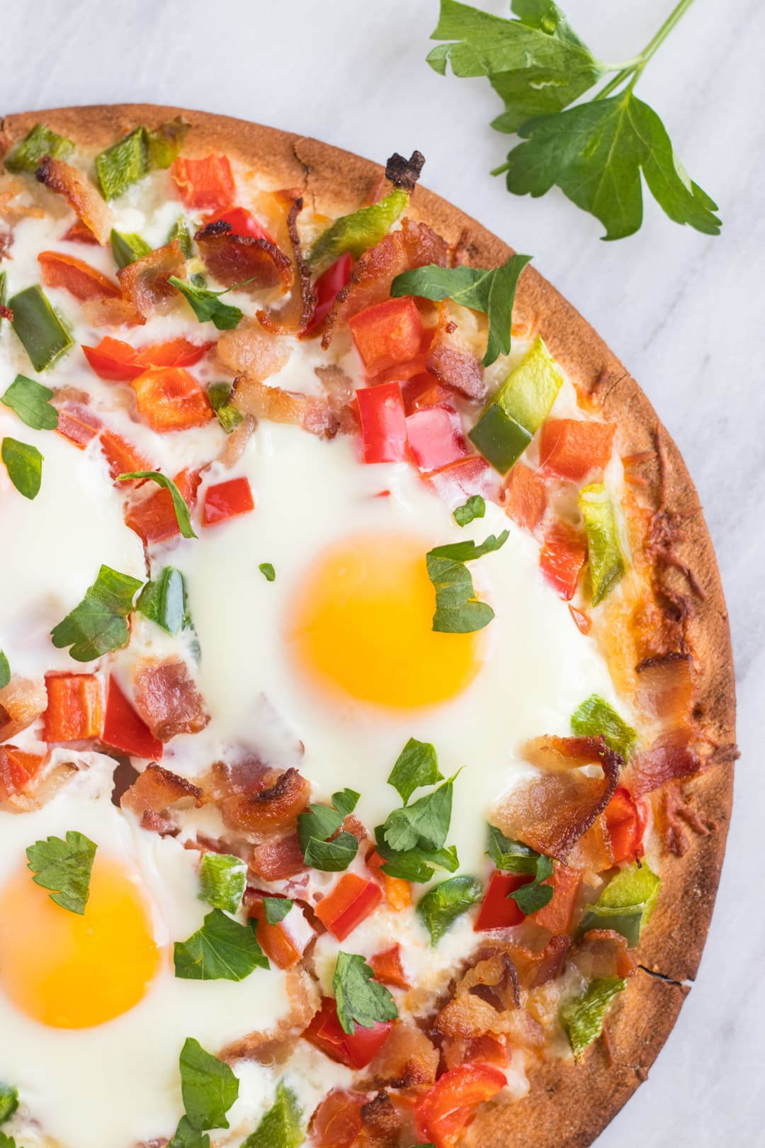 Close up of low FODMAP breakfast pizza with parsley