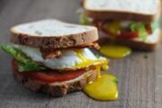 Vertical close up of two low FODMAP BLT sandwiches