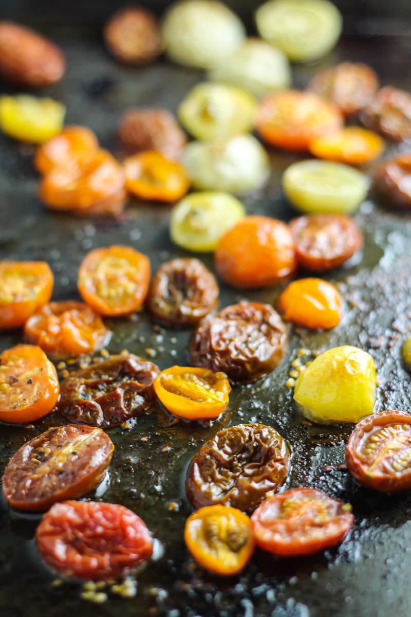 Sheet pan with multi-color roasted tomato halves.