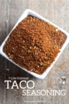Low FODMAP Taco Seasoning in a small white dish on a wood surface