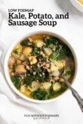A serving of kale, potato and sausage soup in a bowl. In the white space above, black text reads "Low FODMAP Kale, Potato, and Sausage Soup