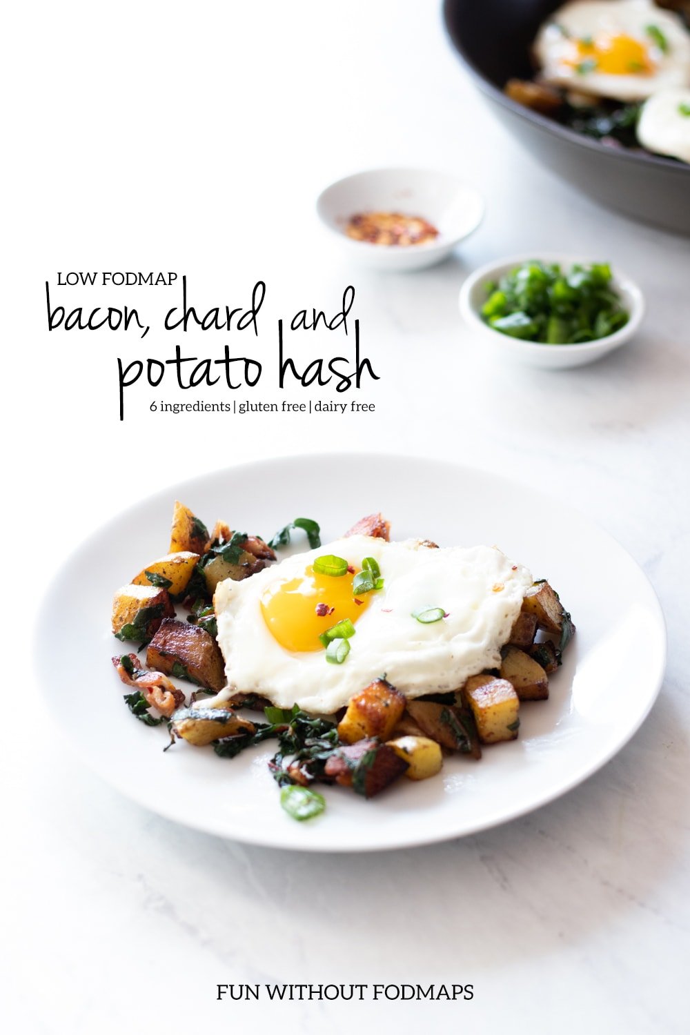Plate of low FODMAP bacon, chard, and potato hash and skillet in the background. In the white space, black text reads "Low FODMAP bacon, chard, and potato hash."