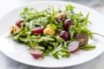 Side shot of low FODMAP arugula salad with grapes