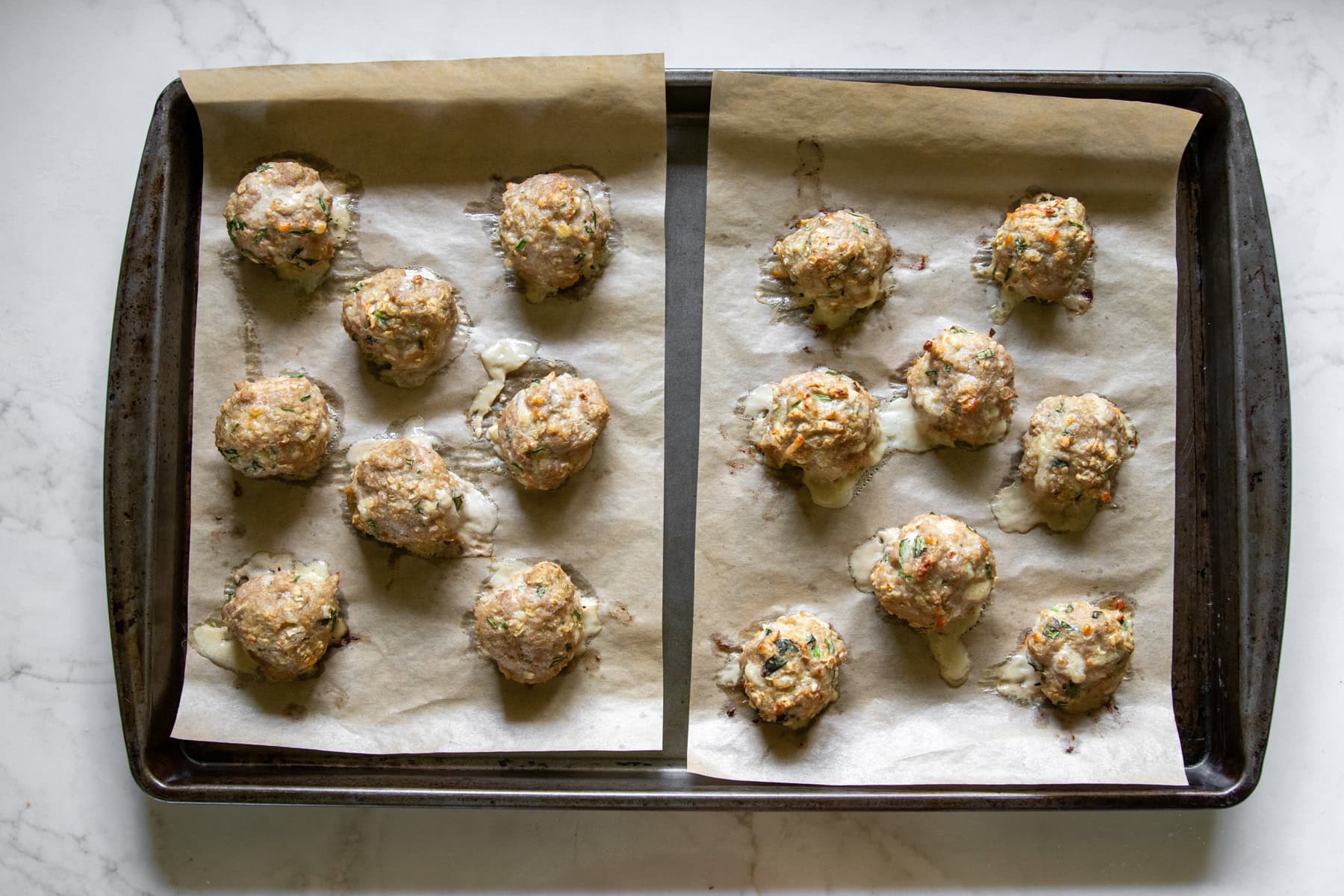 Baked low FODMAP pesto turkey meatballs on a sheet pan.