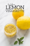 Low FODMAP lemon vinaigrette in a small clear glass cup.