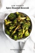 A bowl of roasted broccoli. In the white space above, black text reads "low FODMAP spicy roasted broccoli".