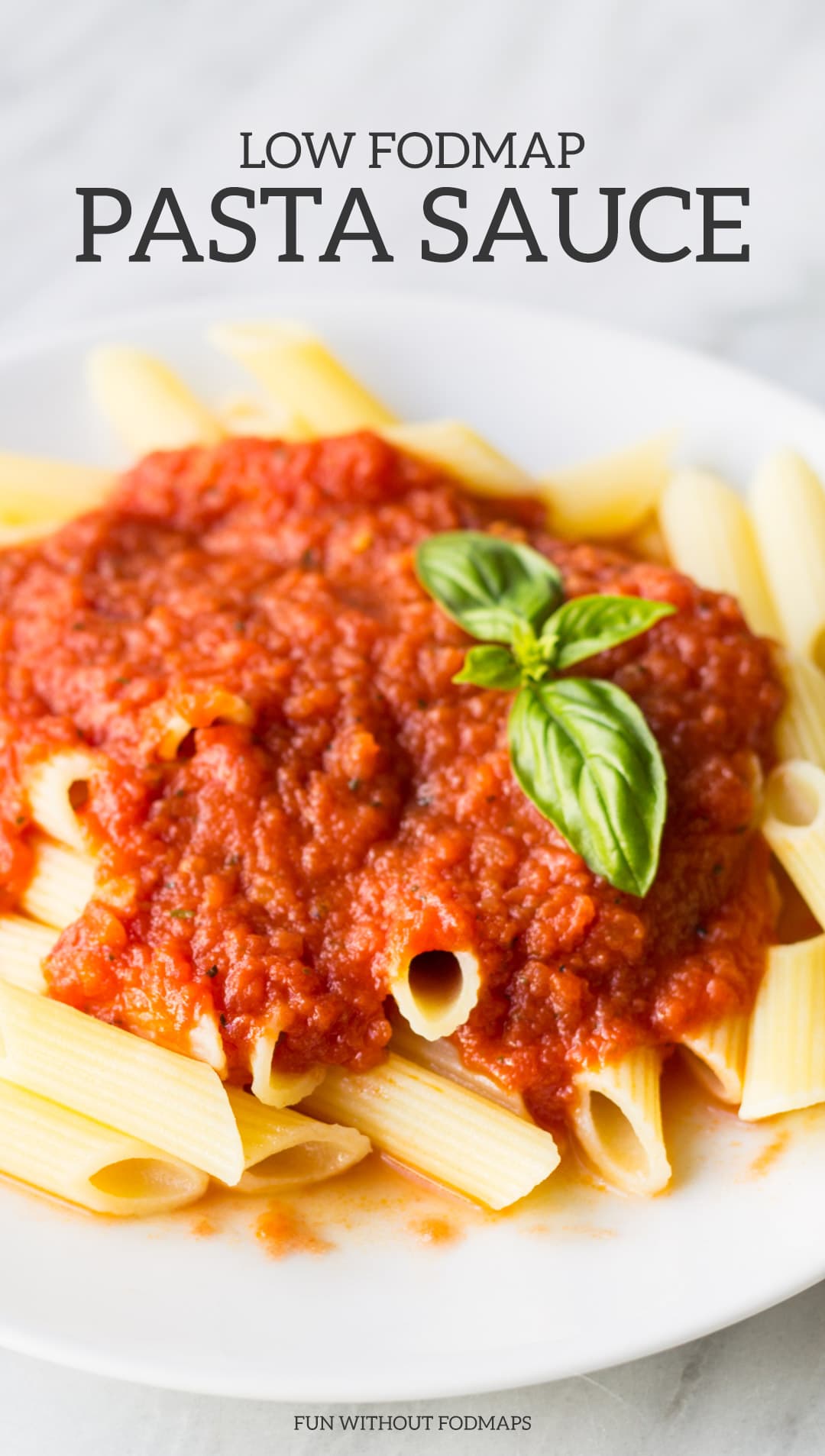 A plate of pasta topped with tomato sauce. Black text above the plate reads "Low FODMAP Pasta Sauce."