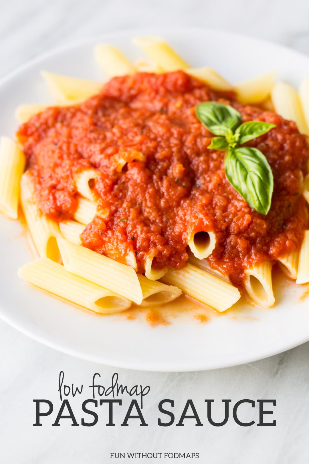 A plate of pasta topped with tomato sauce. Black text below it reads "Low FODMAP Pasta Sauce."