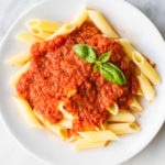 Overhead centered shot of low FODMAP pasta sauce over gluten free penne