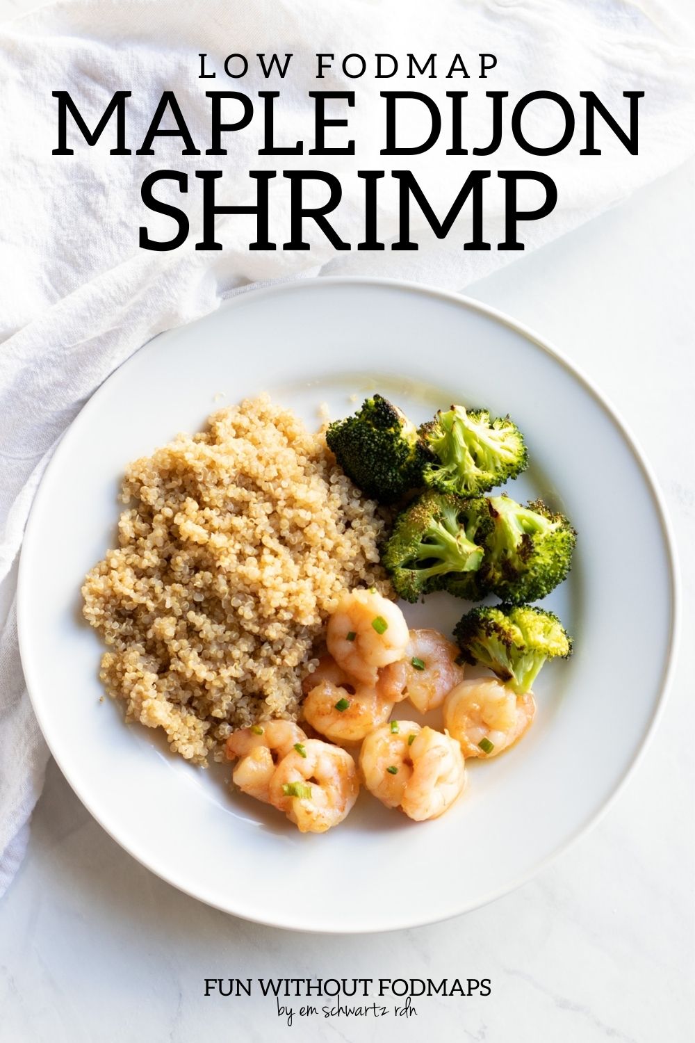 A plate with maple-dijon shrimp, cooked quinoa, and roasted broccoli. In the white space above the plate, text reads "Low FODMAP Maple-Dijon Shrimp."