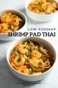Three bowls of Pad Thai with Shrimp sitting on a white marble counter. In the white space in between, black text reads "Low FODMAP Shrimp Pad Thai."