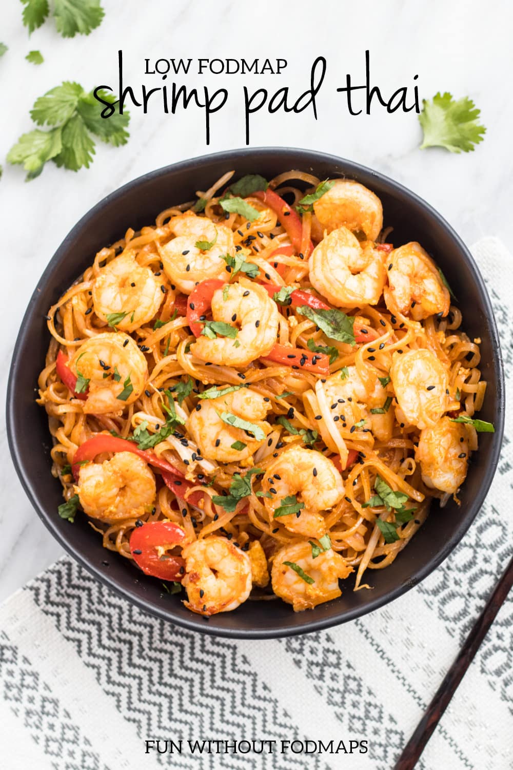 An overhead shot of a black bowl filled with low FODMAP shrimp pad thai. Black text reads "low FODMAP shrimp pad thai" centered at the top of the image.