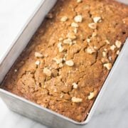 A square image of a bread loaf pan filled with low FODMAP banana bread