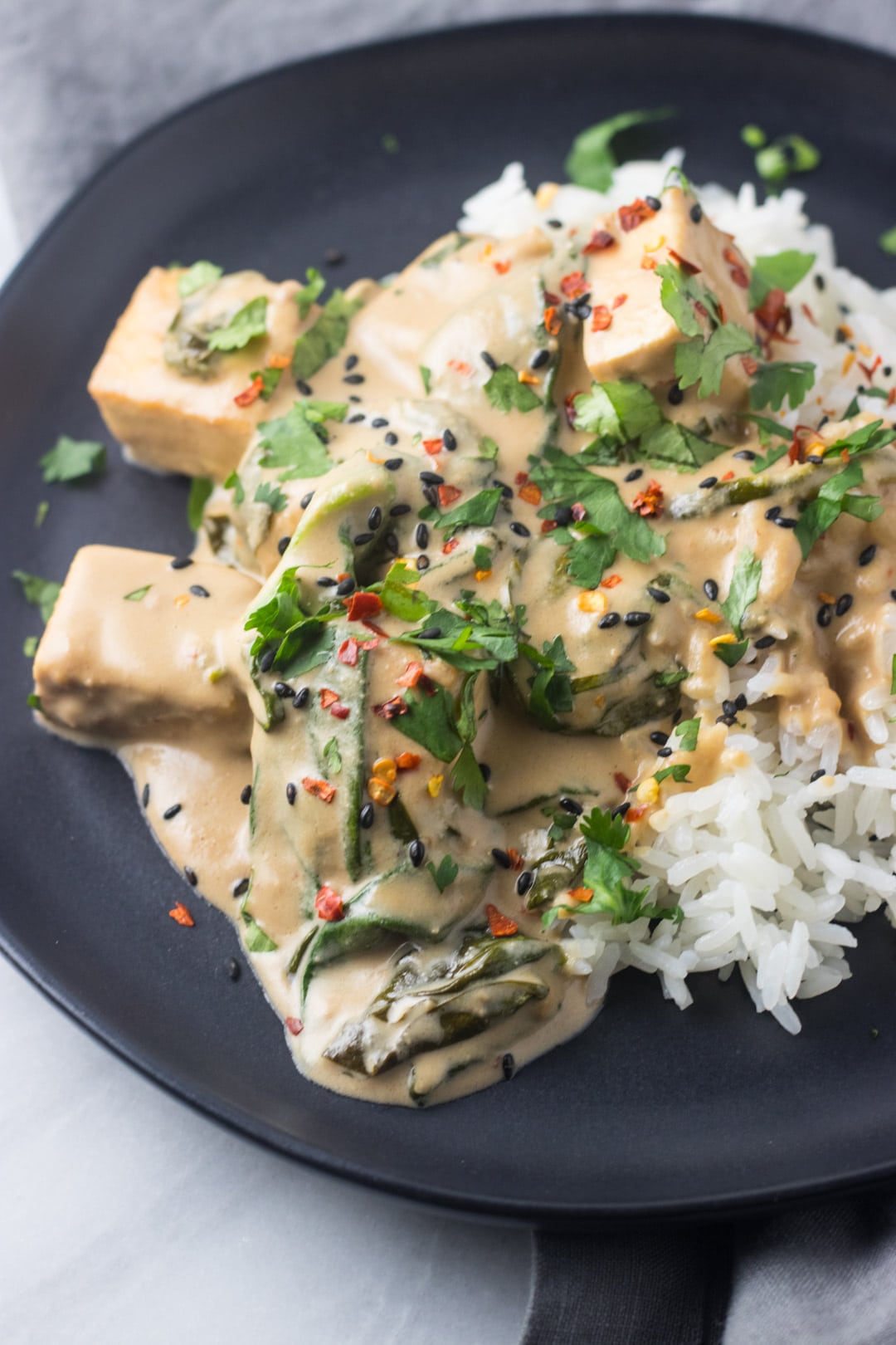 Low FODMAP Thai Pra Ram Tofu on a black plate