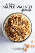 A close up of low FODMAP granola in a mason jar. In the white space above, black text reads "Low FODMAP Maple-Walnut Granola."