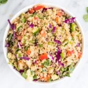 A bowl of a quinoa salad studded with colorful veggies.