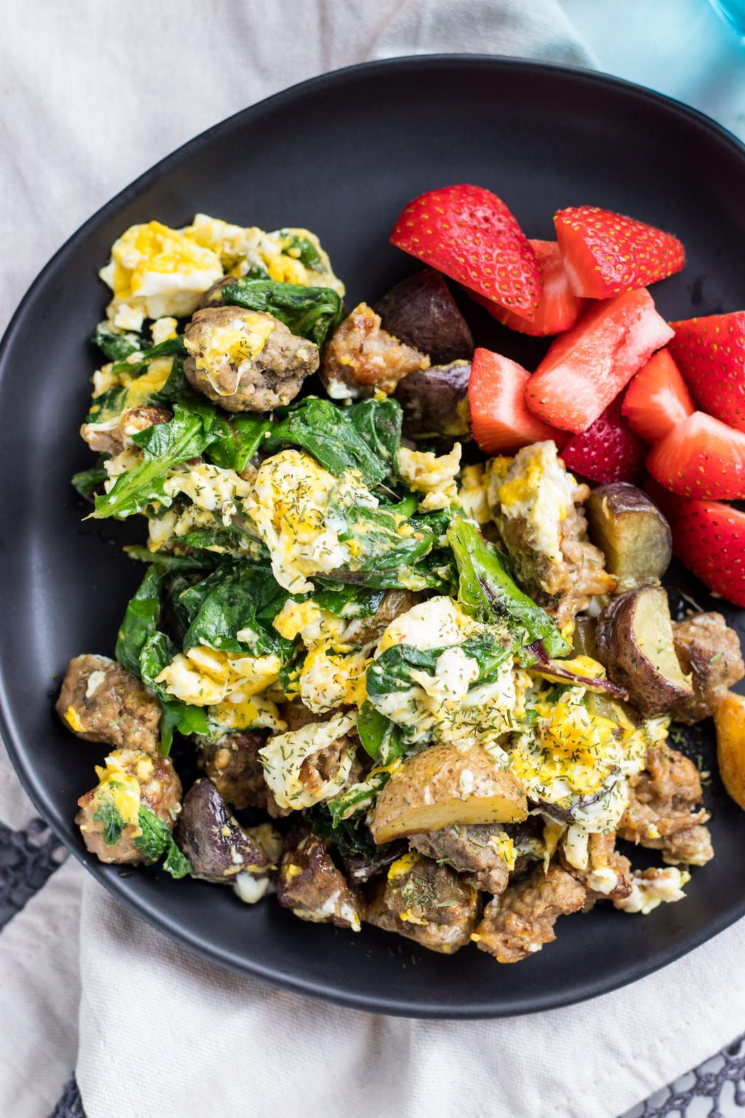 A close up of my go-to low FODMAP breakfast. It's filled with roasted potatoes, homemade sausage, eggs, and cooking greens. 