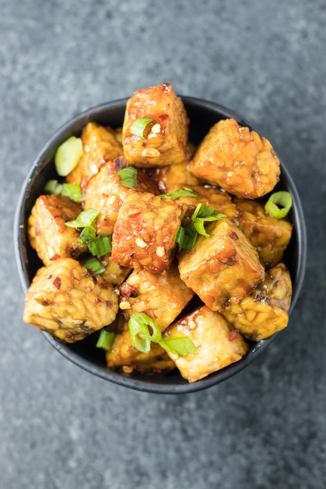 Fried tempeh cubes tossed in a maple-soy glaze and topped with sliced green onions