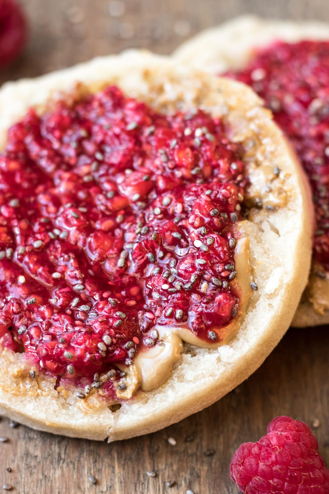 A close-up of raspberry chia jam on an English muffin. 