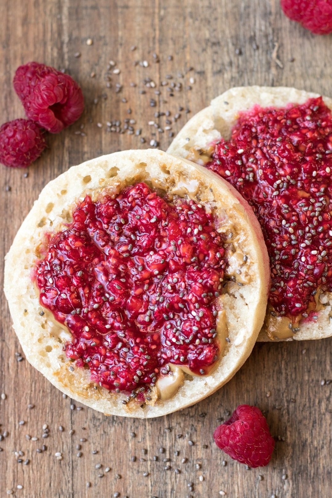 English muffin topped with peanut butter and raspberry chia jam. 