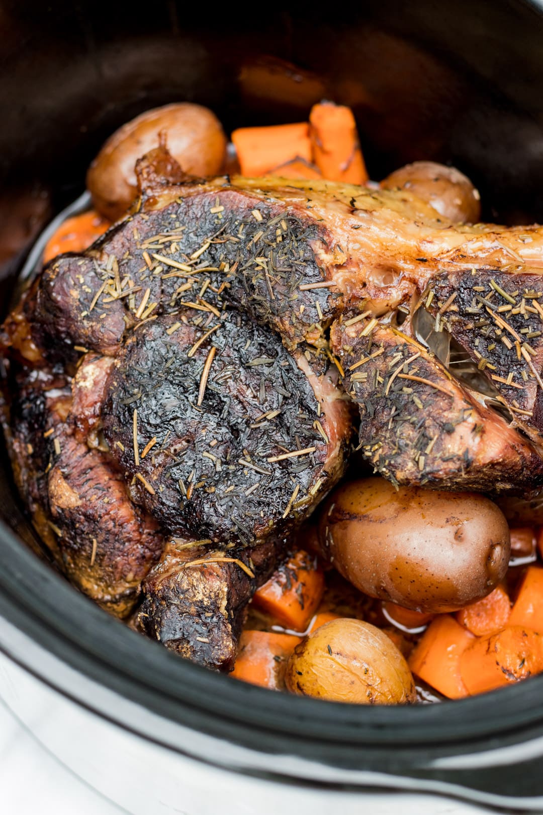 A close up of beef roast cooked in a slow cooker.