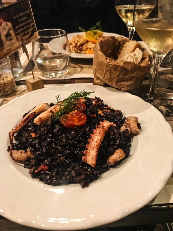 Nero Beppino Risotto - black rice risotto topped with mixed seafood - at Risotteria Melotti in Rome Italy