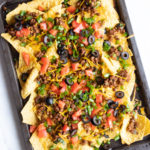 A sheet pan filled with loaded low FODMAP lentil nachos.