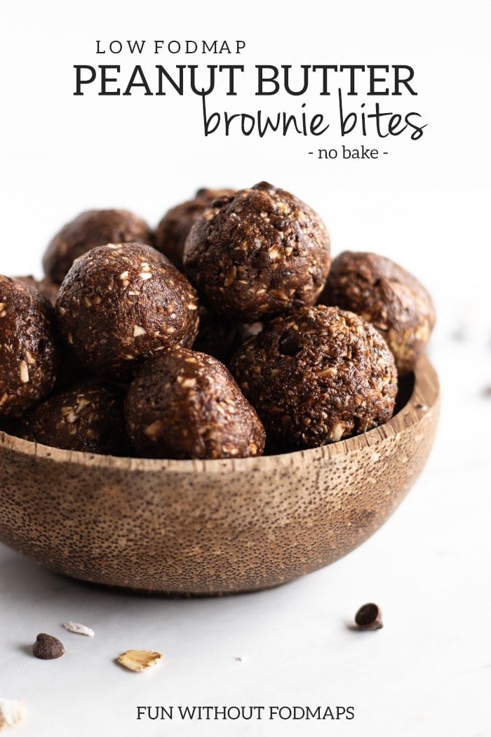A coconut shell bowl filled with bite-sized energy balls. Dark gray text in the upper third says low FODMAP peanut butter brownie bites - no bake - and centered at the very bottom text reads FUN WITHOUT FODMAPS.