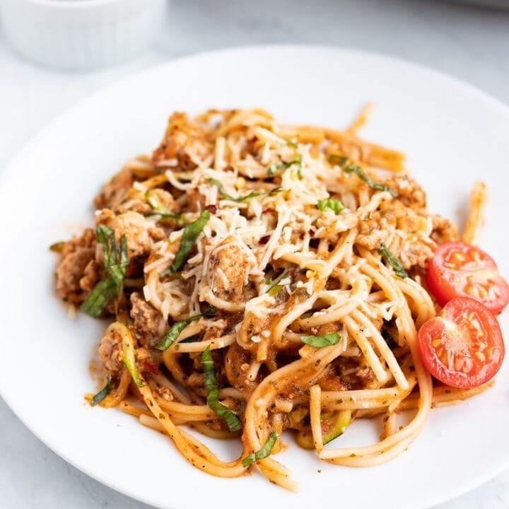 A close up of a white plate filled with low FODMAP spaghetti and zoodles