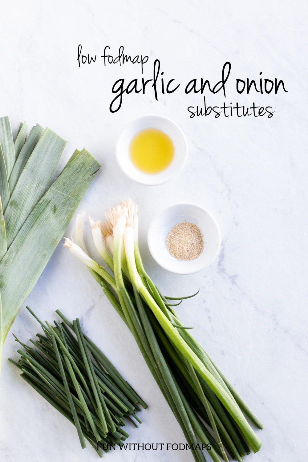 Leeks, green onion tops, asafoetida powder, infused oil, and chives on a white marble background