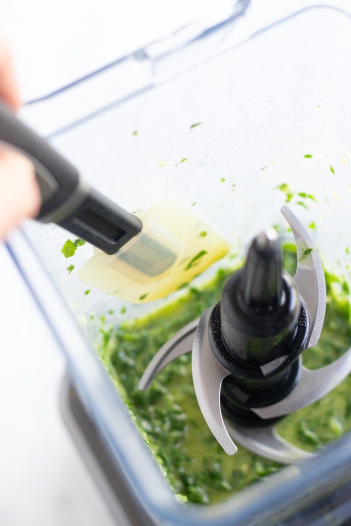 Scraping the sides of the blender to get all of the yummy chimichurri flavor.