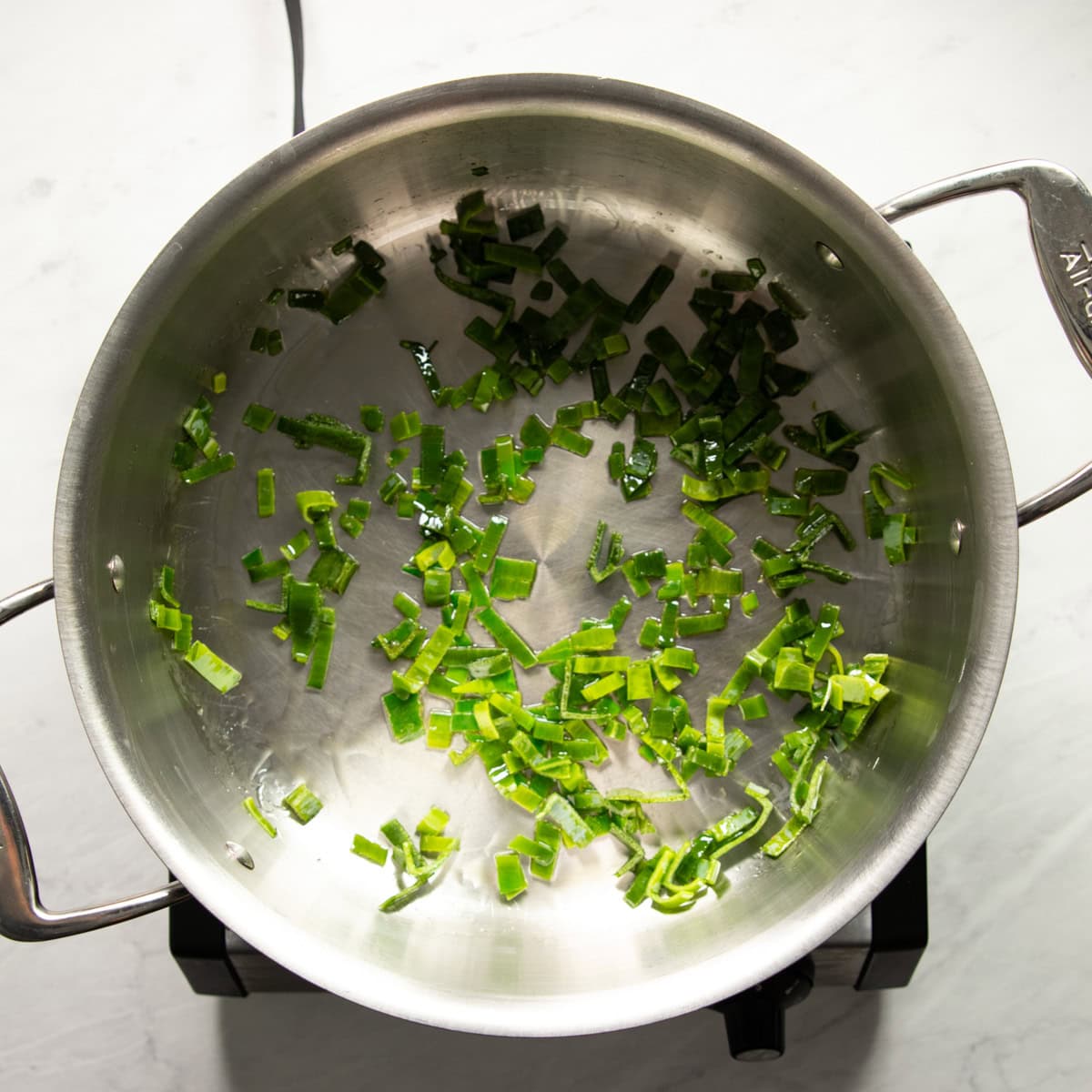 Sauteing leek leaves in garlic-infused oil