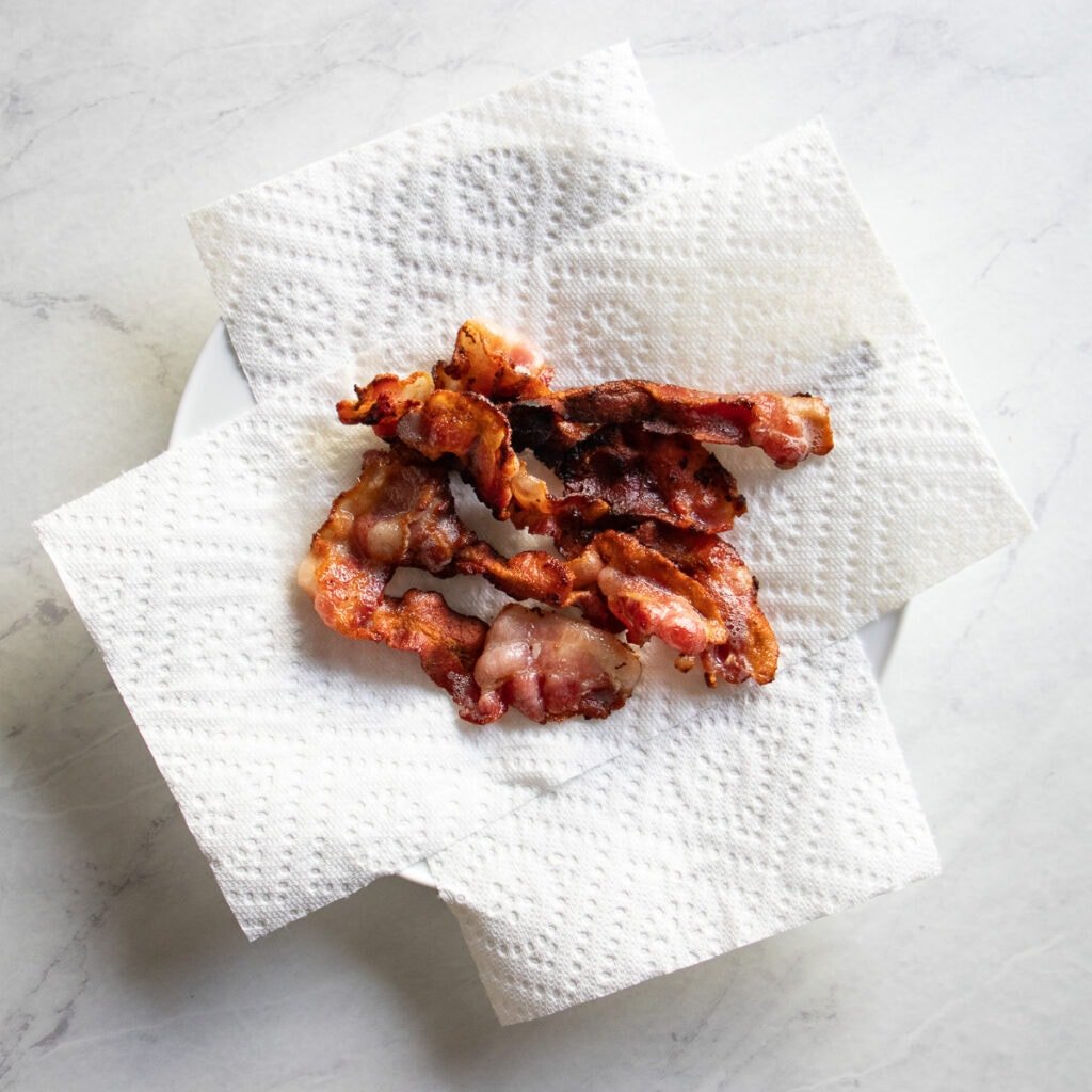 crispy bacon on paper towel-lined plate