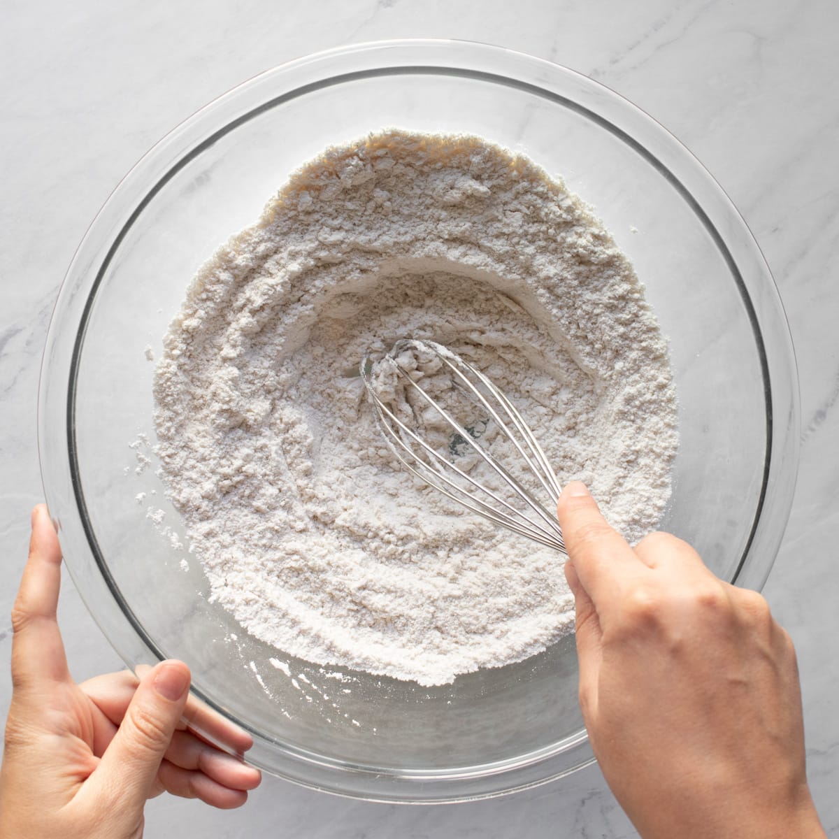 Whisking gluten-free flour, baking powder, and salt.