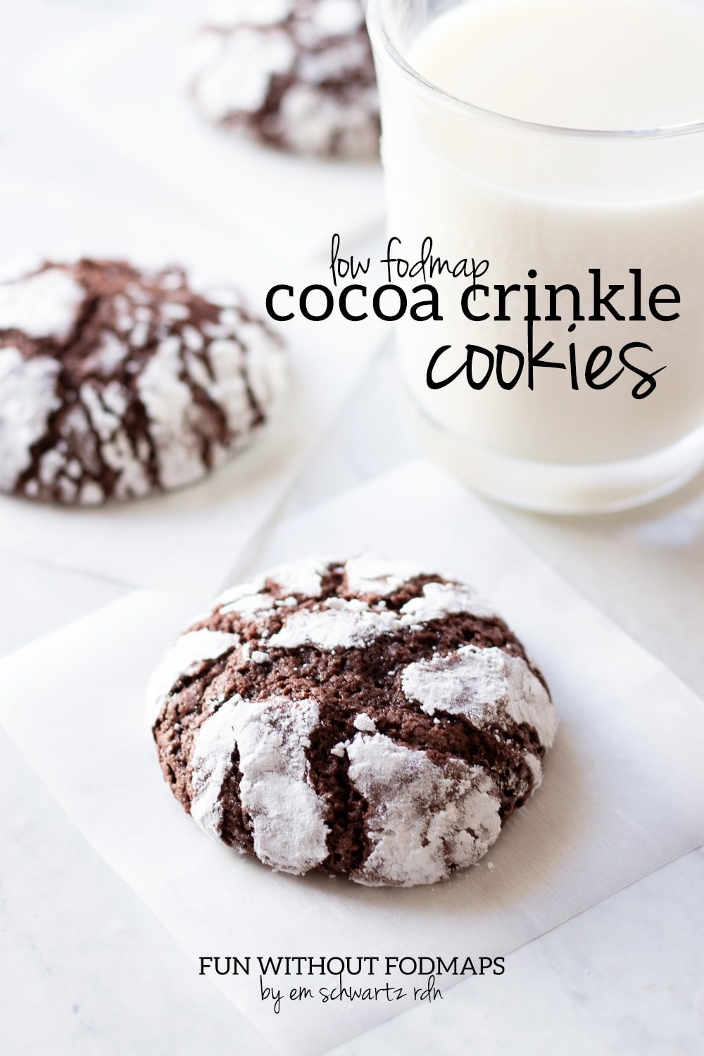 Baked cocoa crinkle cookies with a glass of milk and a black text overlay reading low FODMAP cocoa crinkle cookies