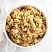 A white bowl filled with low FODMAP quinoa with cranberries and almonds