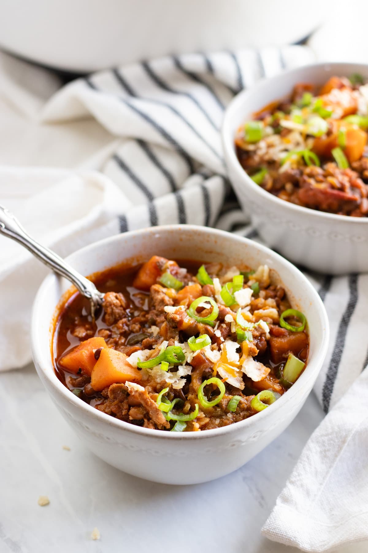 Two bowls of low FODMAP chili made with turkey, sweet potatoes, and lentils.