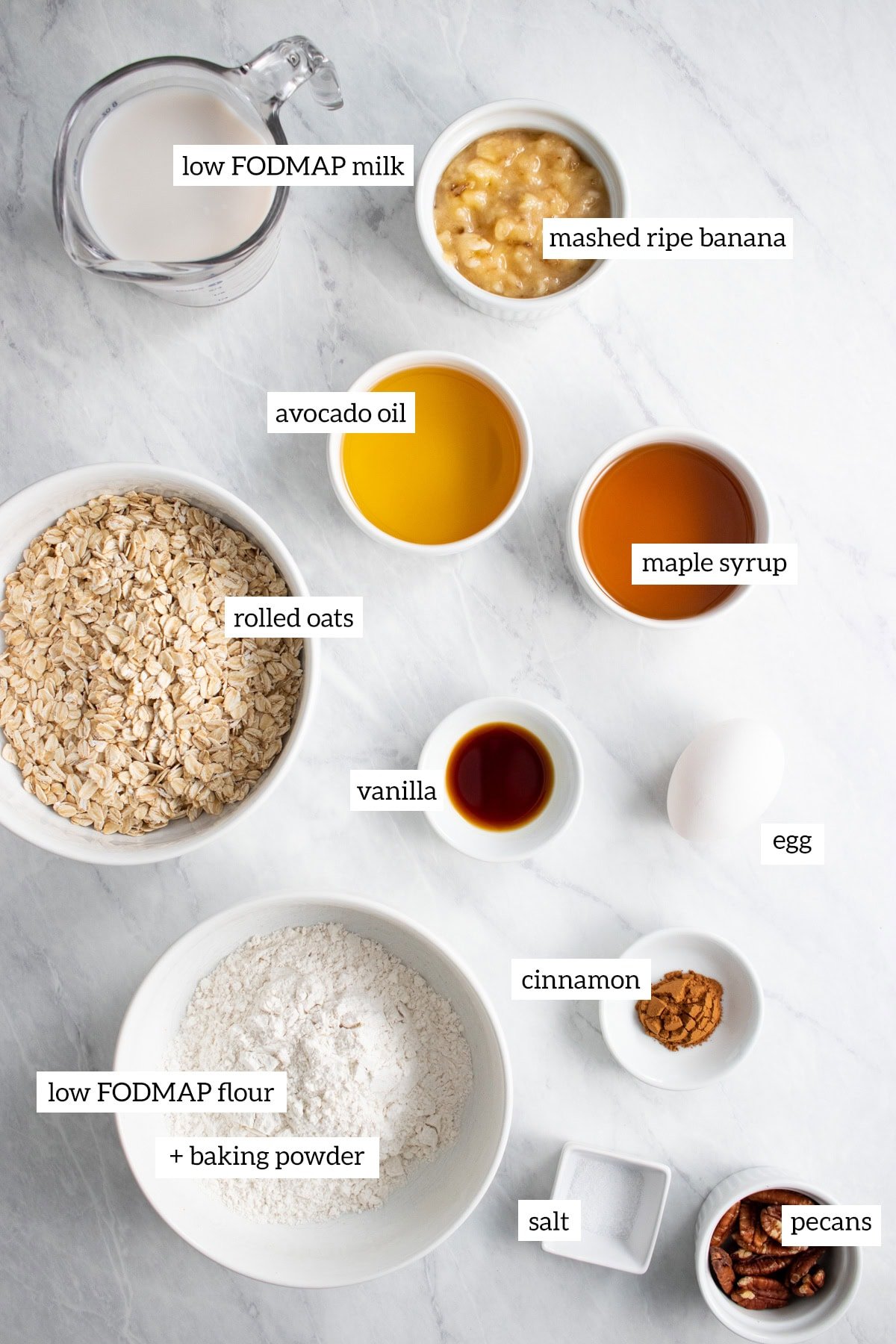 The ingredients needed to make baked oatmeal muffins are prepared and measured out into individual dishes. 