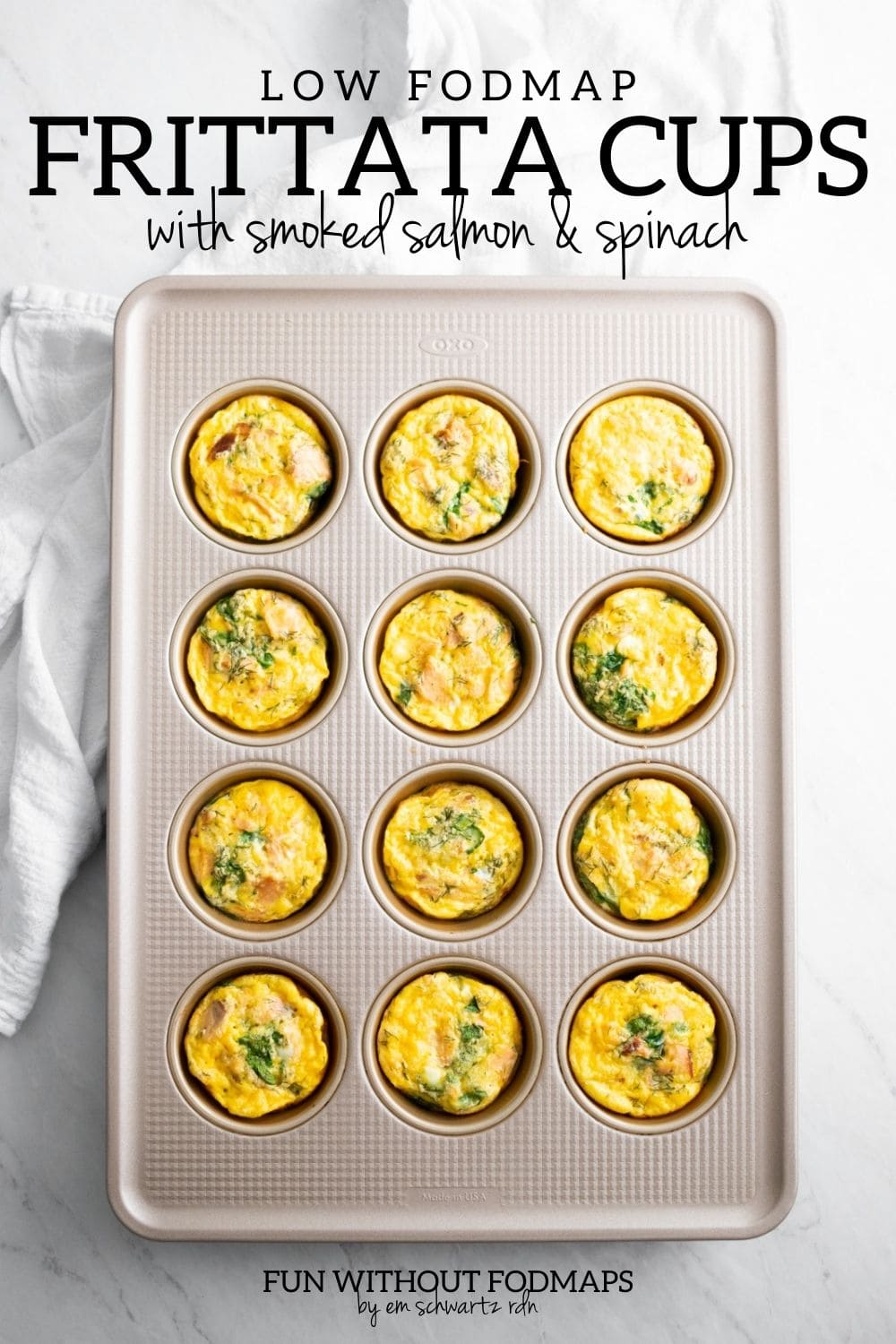 A muffin tin filled with baked egg muffins. In the white space above, black text reads "Low FODMAP Frittata Cups with Smoked Salmon and Spinach"