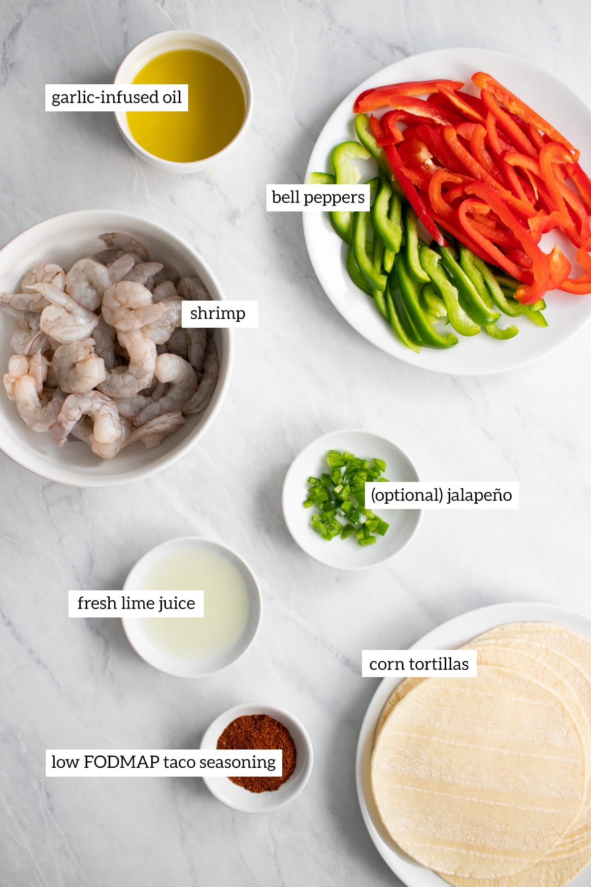 Ingredients needed for low FODMAP shrimp fajitas measured out into individual white dishes.
