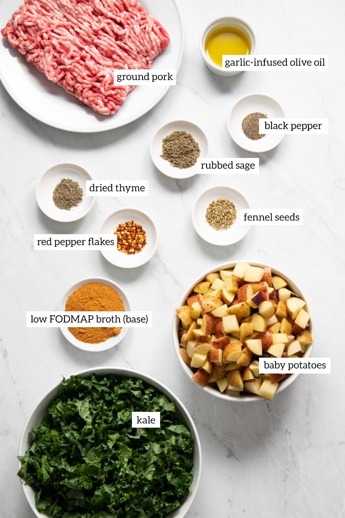 The ingredients needed to make Low FODMAP Kale, Potato, and Sausage Soup are prepared and measured out into individual containers. Each ingredient is labeled with black text.