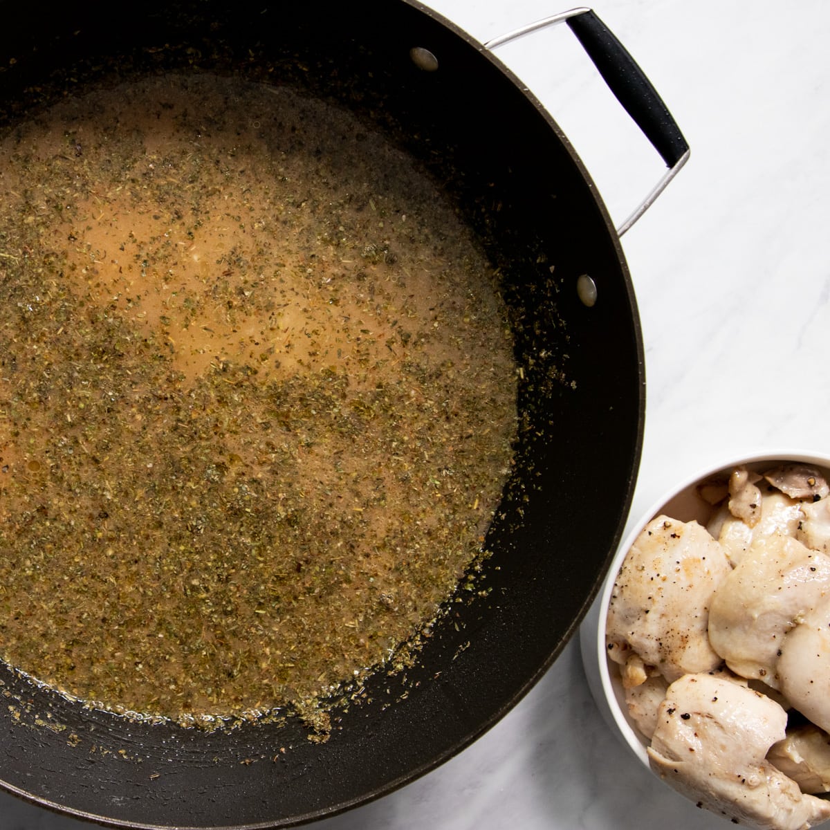 On the left side of the image, a skillet contains rice, chicken broth, lemon juice and Italian seasoning. In the lower right corner, a bowl contains browned chicken thighs.