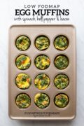 A muffin tin filled with veggie-filled egg muffins. In the white space above, black text reads "Low fODMAP Egg Muffins with Spinach, Bell Peppers & Bacon."