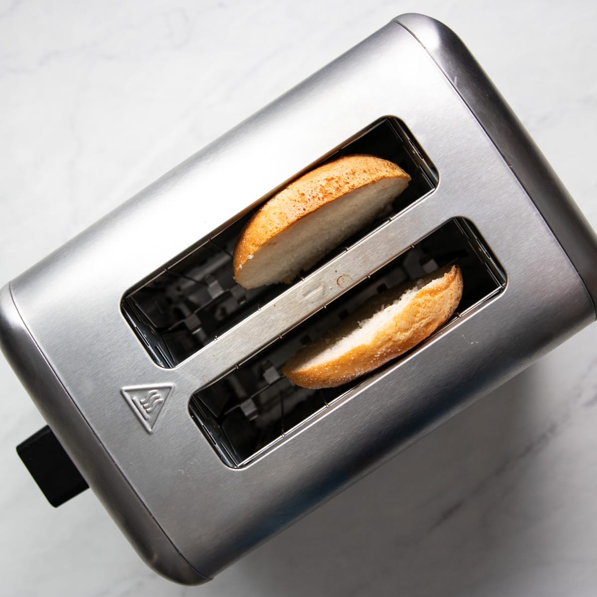 English muffin halves sitting in a toaster